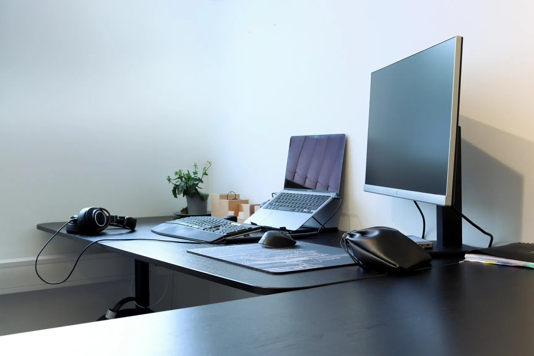 Monitor and a laptop on an office desk